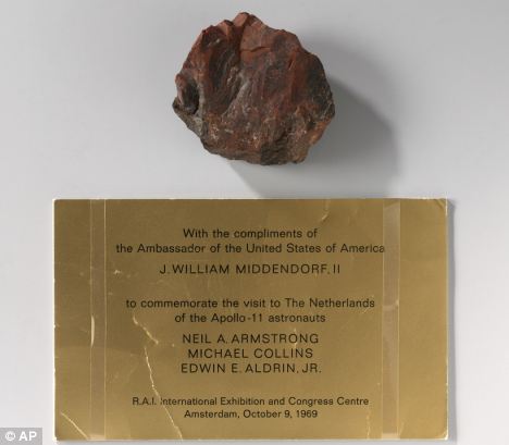 Prized possession: A piece of moon rock on display at the Dutch national museum has been revealed to be a piece of petrified wood after an investigation